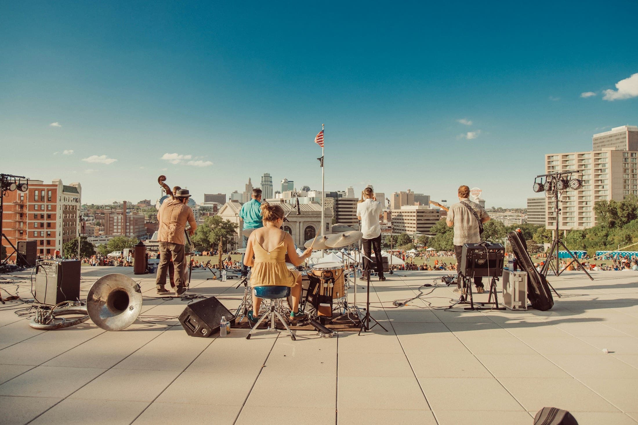 Musicians performing above the Kansas City skyline